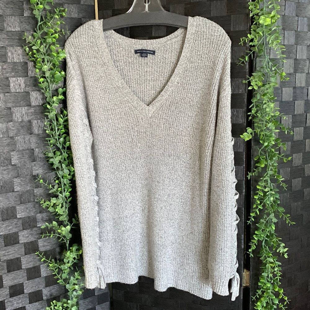 American Eagle Size Small v-neck sweater with shoelace sleeves detail.